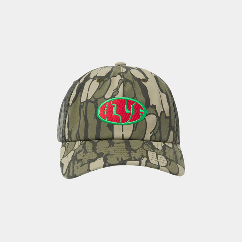 HUF(ハフ)/ WARPED CAMO TRUCKER HAT -CAMO-